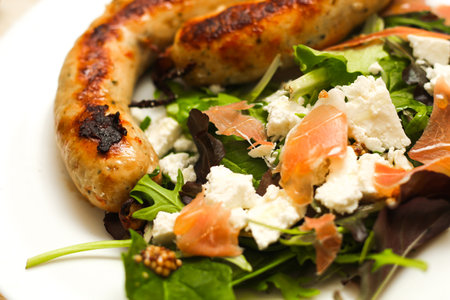 Salad with feta cheese with arugula and fried sausage.の写真素材