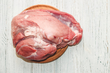 Fresh piece of meat large pork ham on the board.の写真素材