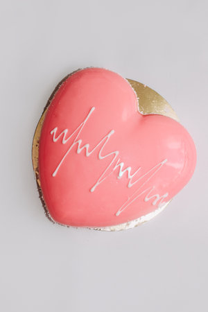 Heart shaped pink mousse cake on the table.の写真素材