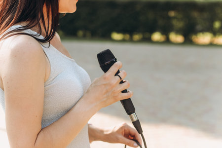 Musician girl holding a microphone for vocals.の写真素材