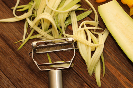 Chopped vegetables, carrots, peppers, zucchini on a vegetable peeler.の写真素材