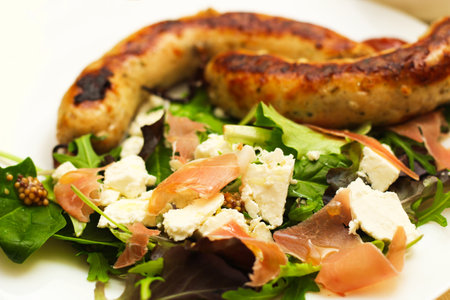Salad with feta cheese with arugula and fried sausage.の写真素材