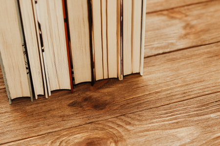A stack of books stand on the tables, stacked in the frame.の写真素材