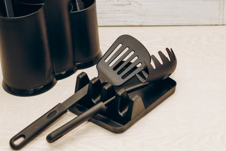 Kitchen tools plastic for multicooker on a wooden table in a dish organizer.の写真素材