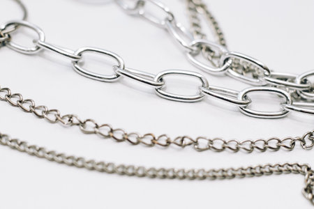 Different silver metal chains on a light background.の写真素材