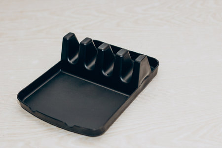 Plastic black coaster for dishes, a handy thing in the kitchen, space organization.の写真素材