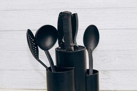 Kitchen tools plastic for multicooker on a wooden table in a dish organizer.の写真素材