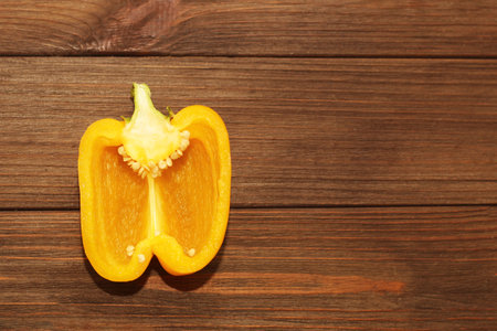 yellow sweet pepper on a wooden background, space for text.の写真素材