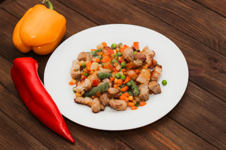 Stewed vegetables with meat, vegetables carrots, peas, beans in a plate.の写真素材