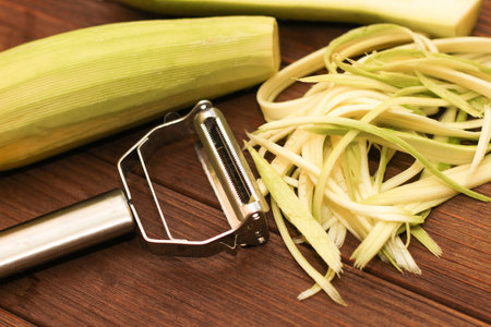 Chopped zucchini into strips, with a light green peeler.の写真素材