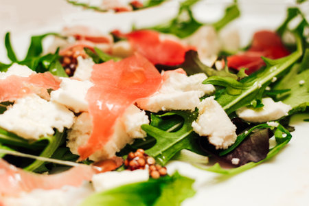 Salad with feta cheese with arugula and fried sausage.の写真素材