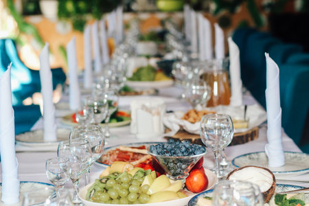 Banquet table served with dishes and snacks.の写真素材