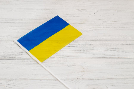 Ukrainian blue yellow flag on a wooden white background.の写真素材