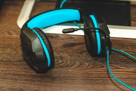 Gaming headphones with a microphone headset on the table.の写真素材