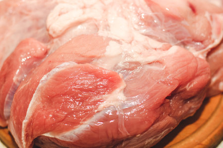 Fresh piece of meat large pork ham on the board..の写真素材