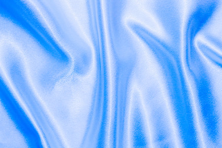 Blue shiny texture of silk satin satin with folds.の写真素材
