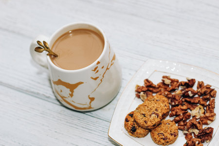 Healthy breakfast oat round granola with nuts on a plate and coffee, seed cookies.の写真素材