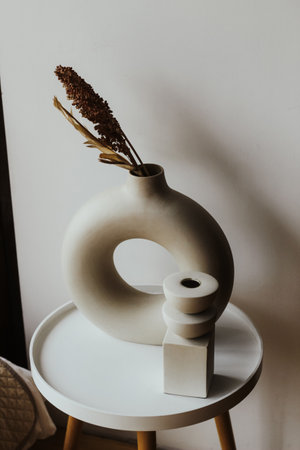 A modern vase with plaster decor in a cozy interior.の写真素材