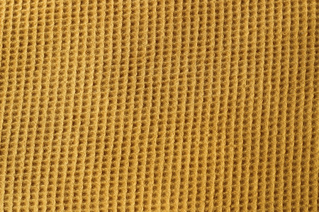 Fabric square knitted texture of mustard color.の写真素材