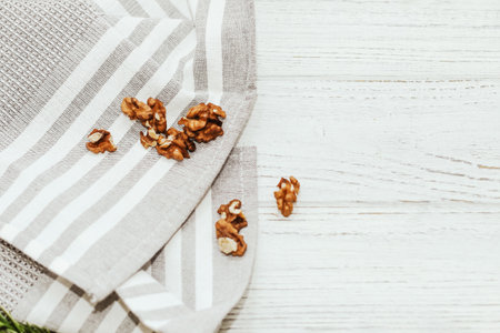 Fresh shelled walnuts on table with kitchen towel.の写真素材