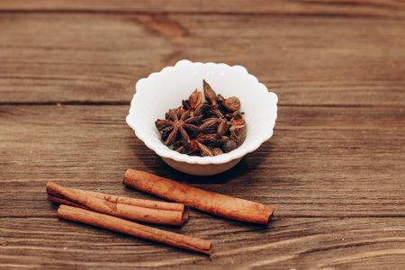 Spices anise, pepper, cumin, cumin, ginger in bowls on a wooden table.の写真素材