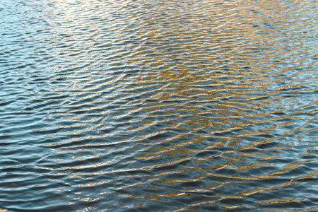 river surface texture, waves shining in the sun.の写真素材