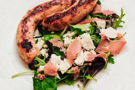 Salad with feta cheese with arugula and fried sausage.の写真素材
