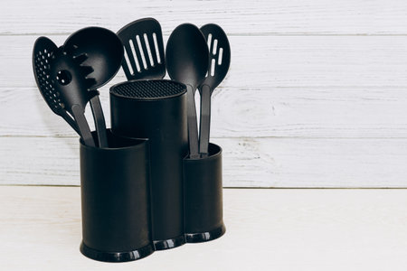 Kitchen tools plastic for multicooker on a wooden table in a dish organizer.の写真素材
