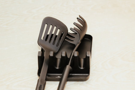 Kitchen tools plastic for multicooker on a wooden table in a dish organizer.の写真素材