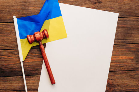 Ukrainian blue yellow flag with judge's gavel on wooden background.の写真素材