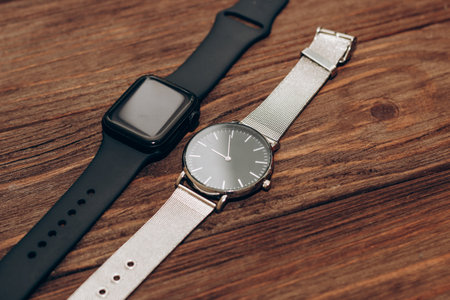 Black technological smart watches and ordinary mechanical watches with a dial.の写真素材