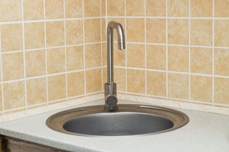 A sink with a faucet in the kitchen.の写真素材