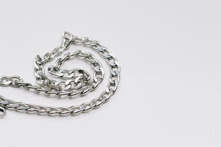 Different silver metal chains on a light background.の写真素材
