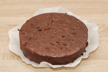 Chocolate round glazed cake with peanuts.の写真素材