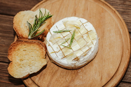 White baguette cut into pieces with olive oil and Camembert cheese on the table.の写真素材