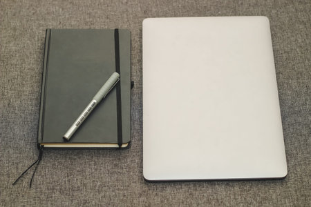 Laptop series flat metal on the table with a business diary.