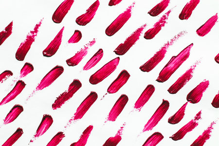 Smears of red cosmetic lipstick on a light background.の写真素材