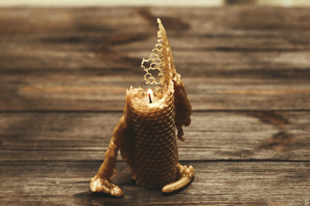 A candle made of natural wax is half burnt.の写真素材