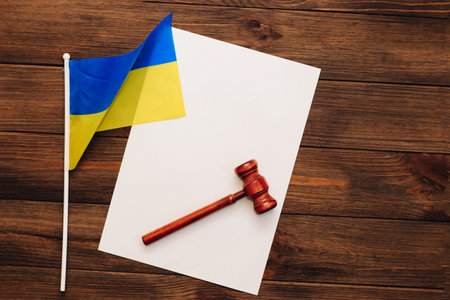 Ukrainian blue yellow flag with judge's gavel on wooden background.の写真素材