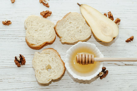 Pieces of ripe pear with croutons with honey on the kitchen table.の写真素材