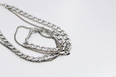 Different silver metal chains on a light background.の写真素材