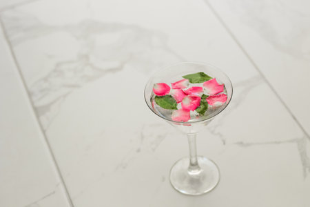Rose petals in a martini glass, concept of beauty, style and fashion.の写真素材