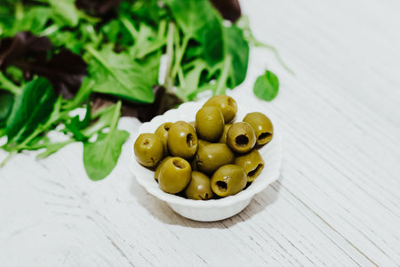 Mix of lettuce leaves different types with olives.の写真素材