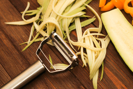 Chopped vegetables, carrots, peppers, zucchini on a vegetable peeler.の写真素材