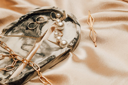 Women's jewelry, gold chain, trendy jewelry on a silk background.の写真素材