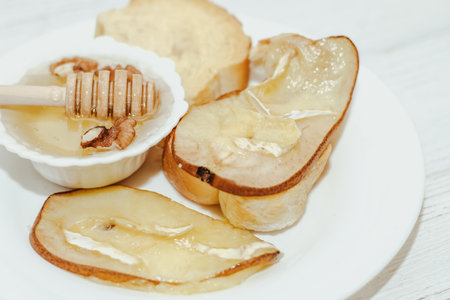 Camembert cheese with olive oil, rosemary, honey and baked pear.の写真素材
