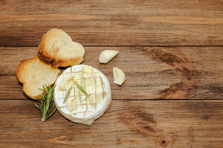 White baguette cut into pieces with olive oil and Camembert cheese on the table.の写真素材
