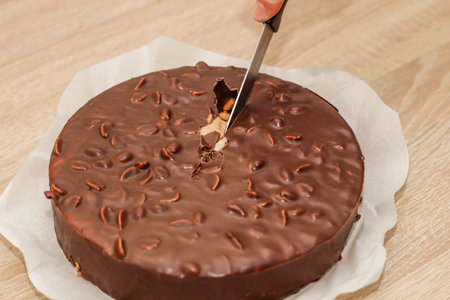 Chocolate round glazed cake with peanuts.の写真素材