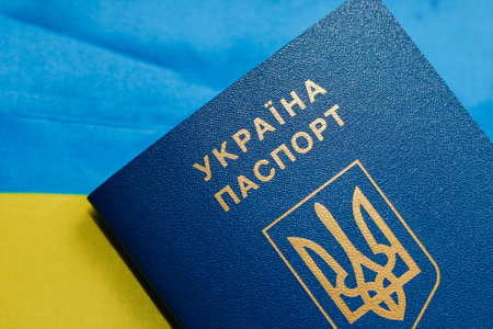 Ukrainian passport with the flag of Ukraine on a wooden table.の写真素材