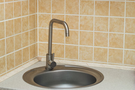 A sink with a faucet in the kitchen.の写真素材